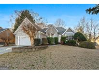 Charming home features a two-car garage and well-maintained landscaping at 140 Jodeco Station Ter, Stockbridge, GA 30281