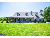 Charming single-story home featuring a welcoming front porch, dormer windows, and a well-manicured front yard at 640 Lovell Rd, Temple, GA 30179