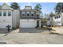 Charming two-story home with a two-car garage and modern architectural details in a suburban neighborhood at 807 Stickley Oak Way, Woodstock, GA 30189