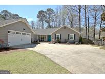 Charming single-story home with attached garage, large driveway, and inviting curb appeal at 200 Doe Run, Peachtree City, GA 30269
