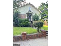 Modest home featuring a classic design and a well-maintained lawn with mature landscaping at 466 Joseph E Lowery Nw Blvd, Atlanta, GA 30314