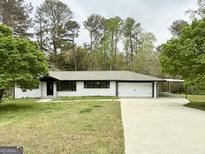 Charming single story home with brick exterior, attached garage, and concrete driveway and carport at 1322 S Hicks Cir Nw, Conyers, GA 30012