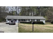 Charming single story home featuring a welcoming front porch and driveway at 2387 Shire Ct, Austell, GA 30106
