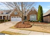 Charming brick home with well-manicured landscaping, a two-car garage, and inviting curb appeal at 365 Grand Teton Cir, Fayetteville, GA 30215