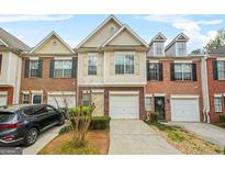 Charming townhome featuring a brick facade, attached garage, and well-maintained landscaping in a desirable neighborhood at 784 Brookside Parc Ln, Avondale Estates, GA 30002