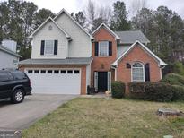 Charming two-story home with a two-car garage, manicured lawn and brick facade at 2160 Creekview Trl, Decatur, GA 30035