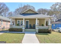 Charming craftsman-style bungalow with a welcoming front porch and well-manicured lawn at 988 Allene Sw Ave, Atlanta, GA 30310