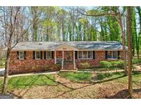 Charming brick home with a well-maintained lawn and inviting front porch at 730 Ponderosa Ct, Fayetteville, GA 30214