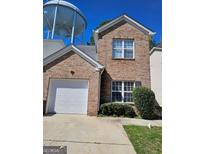 Charming brick two-story home featuring an attached garage and well-maintained landscaping at 530 Shadowmoore Dr, Riverdale, GA 30274