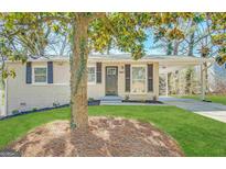 Charming, single-story home with brick facade, well-kept lawn, and inviting covered entry at 3566 Fairlane Nw Dr, Atlanta, GA 30331