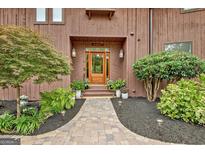 Charming home featuring a landscaped walkway leading to a wood door entrance at 4 & 5 Northlake Cir, Peachtree City, GA 30269