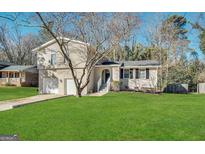 Charming two-story home with a well-maintained lawn, attached garage, and inviting front entrance at 2317 Emerald Springs Dr, Decatur, GA 30035