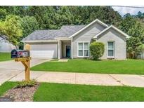 Charming single-story home with manicured lawn and a well-maintained exterior and a convenient attached garage at 710 Thomasville Se Blvd, Atlanta, GA 30315