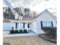 Charming single-story home with blue shutters, a covered porch, and well-maintained landscaping in the front yard at 3353 Medina Dr, Jonesboro, GA 30236