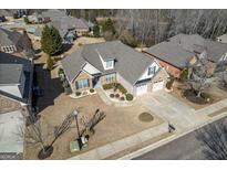 Expansive aerial view of brick and siding home with mature landscaping and a three-car garage at 409 Brandy Ln, Mcdonough, GA 30253