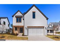 Charming two-story home featuring a white brick facade, wood accents and a two-car garage at 1230 Hayes Sq, Peachtree City, GA 30269