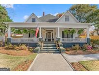 Charming home features an inviting front porch, manicured lawn, and classic architectural details at 2173 Conyers Se St, Covington, GA 30014