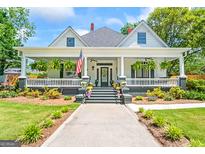 Charming home featuring a wide front porch, lush landscaping, and an inviting walkway to the front door at 2173 Conyers Se St, Covington, GA 30014