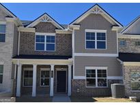 Charming two-story townhome showcasing a mix of brick and siding accents at 4841 Walkers Green, Mableton, GA 30126