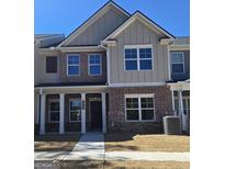 Charming brick and siding home with covered porch, perfect for enjoying the outdoors at 4849 Walkers Green, Mableton, GA 30126