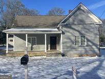 Charming single-Gathering home with a gray exterior, covered porch, and 