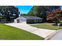 Charming ranch-style home with stone accents, well-manicured lawn, and long driveway at 2329 Prestige Sq, Morrow, GA 30260