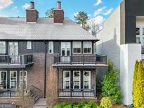 Charming brick townhouse with a cozy balcony and well-maintained landscaping at 434 Selborne Way, Chattahoochee Hills, GA 30268