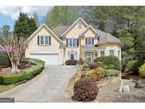 Charming home with a landscaped front yard, driveway, and attached two-car garage at 3450 Merganser Ln, Alpharetta, GA 30022