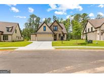 Beautiful two-story home with a stone and siding exterior, two-car garage, and well-maintained lawn at 208 Regester Way # 43, Peachtree City, GA 30269