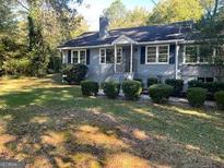 Charming home featuring lush landscaping, mature trees, and traditional curb appeal at 5147 Highpoint Rd, Union City, GA 30291