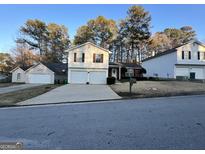 Traditional two-story home with a two-car garage and a well-maintained front lawn at 709 Kilkenny Cir, Lithonia, GA 30058