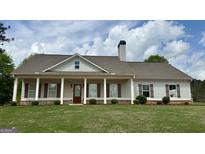 Charming single-Gathering home with a columned front porch and manicured lawn at 4529 Jersey Covington Rd, Covington, GA 30014