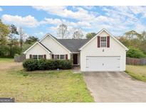 Charming single-Gathering home featuring a two-car garage, landscaped front yard, and a classic design at 1416 Flanagan Mill Dr, Auburn, GA 30011