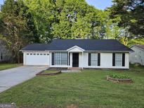 Charming ranch-style home with a well-maintained front yard and a two-car garage at 240 Carsons Cv, Mcdonough, GA 30253
