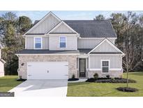 Charming two-story home with a brick and siding facade, attached garage, and well-manicured lawn at 3413 Arabian Farm Ln, Dacula, GA 30019