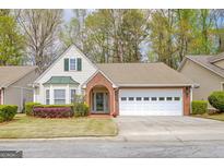 Charming single-Gathering home featuring a two-car garage and a well-manicured front yard at 1010 Pinehurst Dr, Peachtree City, GA 30269