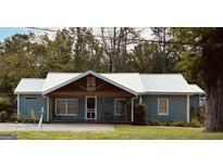 Charming single story home featuring metal roof, welcoming porch and classic curb appeal at 6121 N Main Se St, Acworth, GA 30101