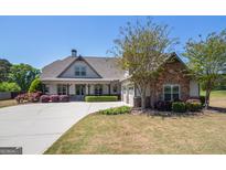 Charming single-Gathering home featuring manicured landscaping and a welcoming entrance at 1 Red Oak Trl, Sharpsburg, GA 30277