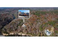 Stunning aerial view of the property nestled in a forest with a river, offering privacy and natural beauty at 3212 Sw Woodhaven Sw Ct, Conyers, GA 30094