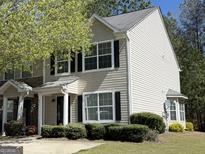 Charming two-story townhome with neutral siding, black shutters, and manicured landscaping at 661 Outlook Way, South Fulton, GA 30349
