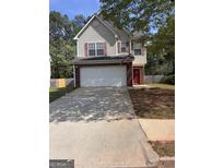 Charming two-story home features a wide driveway and attached two-car garage at 1132 Saint Phillips Ct # 90, Locust Grove, GA 30248