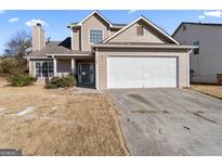 Two-story home with a two-car garage and a front porch at 5728 Rock Shoals Way, Atlanta, GA 30349