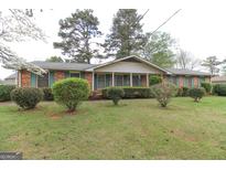 Charming brick home with green shutters and well-maintained landscaping at 3257 Greenvale Way, Decatur, GA 30034
