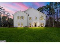 Stunning modern farmhouse with black trim windows and a beautiful green lawn at 130 Wesley Pl, Fayetteville, GA 30214