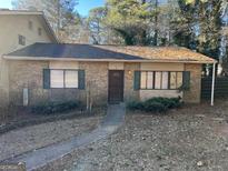 Charming brick home featuring a well-kept lawn, complementing the home's cozy curb appeal at 7560 Taylor Rd # 5, Riverdale, GA 30274