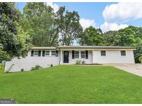 Well-maintained ranch-style home with a lush green lawn and a freshly painted exterior at 6026 S Bear Dr, Douglasville, GA 30135
