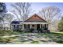 Charming brick home with a welcoming front porch and well-maintained landscaping at 689 Hardin Rd, Temple, GA 30179