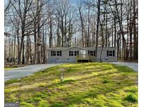 Charming one-story home with a covered front porch and well-maintained lawn at 54 Holly Dr, Carrollton, GA 30116