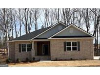Charming, new construction, one-story home featuring a brick facade and a classic gabled roofline with gray accents at 3383 Milan Ct # 4 Plapprox Sqft 1, Douglasville, GA 30135