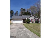 Charming single-story home with a two-car garage and well-maintained front lawn and lovely red shutters at 172 Willow Springs Ln, Stockbridge, GA 30281